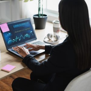 Business trader woman doing blockchain research inside hedge fund office - Focus on left hand