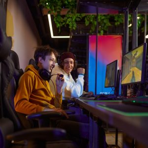 Two young gamers play in game club