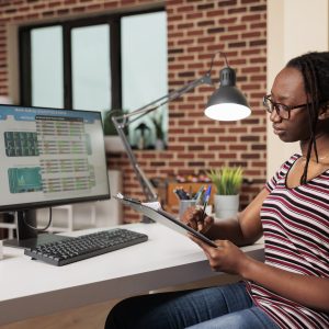 Woman analyzing business statistics, working with internet of things